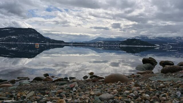 Nature's Harmony: Aerial Views of Shuswap Lake's Calm Waters, Cloudy Skies, and Reflective Beauty