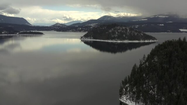 Island Escape: Aerial Footage of Copper Island and Shuswap Lake's Serene Beauty on a Cloudy Day