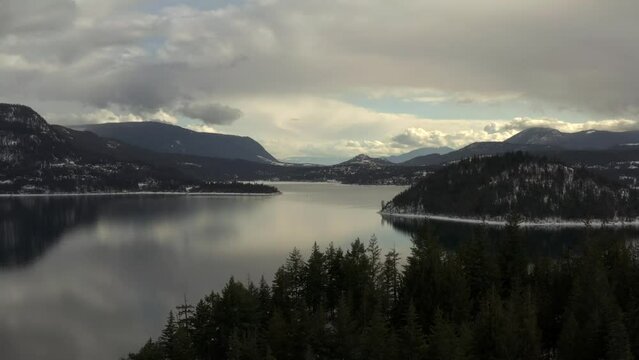 Calm Cloudy Day at Copper Island: Aerial Footage of Shuswap Lake's Tranquil Waters and Majestic Mountains