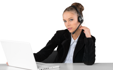 Beautiful young businesswoman with headset working on laptop