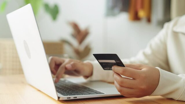 Hand. woman buying, transactions online with credit card on laptop at home