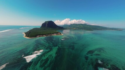 flying high towards le morne underwater waterfall in mauritius bright sunny day drone aerial 4k