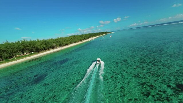 following a speed boat on a paradise island le morne beach in mauritius