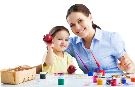 Mother and daughter painting eggs