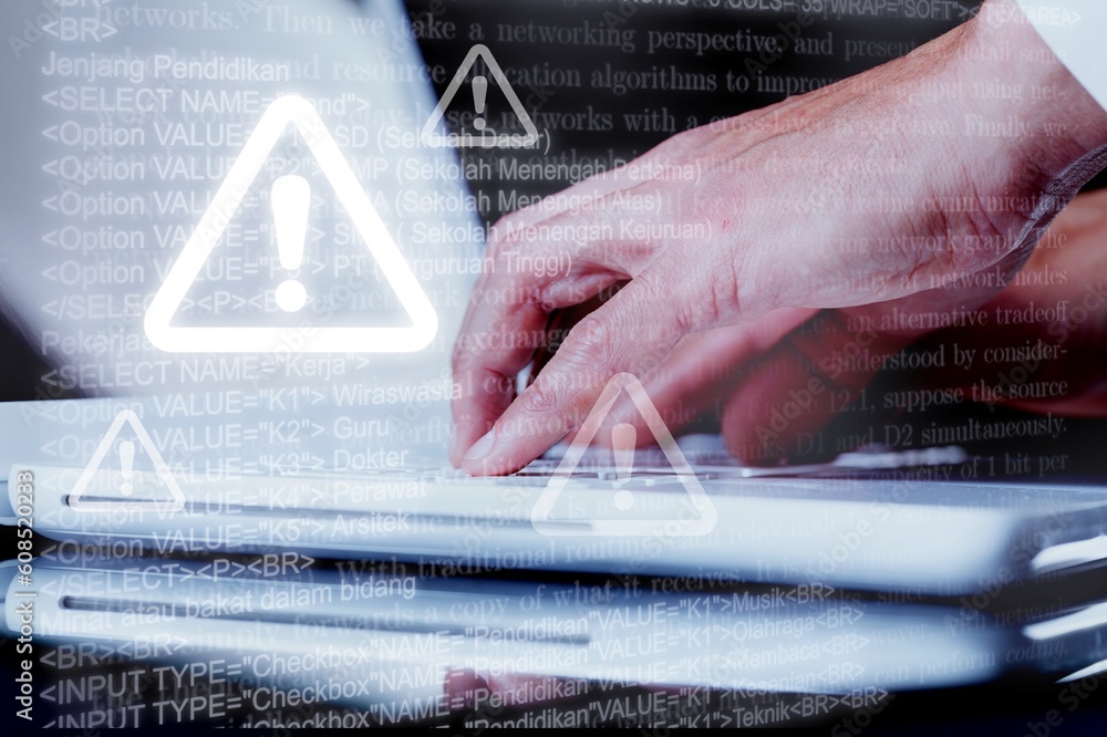 Aufkleber cyber security. man works on computer with alert sign