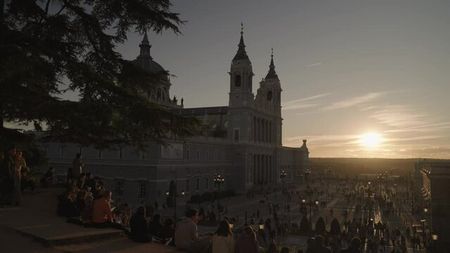 Crowd of People and Catedral de la Almudena during Sunset Madrid, Spain