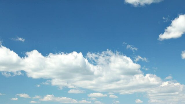 Blue sky with billowing white clouds time-lapse