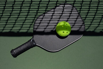 Flatlay of a pickleball paddle and ball