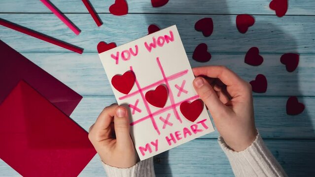 Stop motion Valentines Day. Instructions for making valentine cards. Text YOU WON MY HEART and tic tac toe game Postcard craft, greeting card. DIY Step by step instruction. Making of handmade