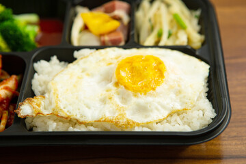 Side dishes and rice in takeout containers
