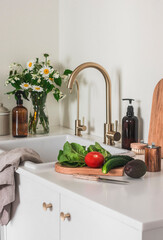 Kitchen interior. Vegetables for salad preparation on the kitchen table