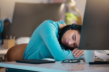 Call center, customer service and a woman consultant sleeping at her desk in the office late at night. Exhausted, overworked and a tired female employee asleep while consulting for crm or sales