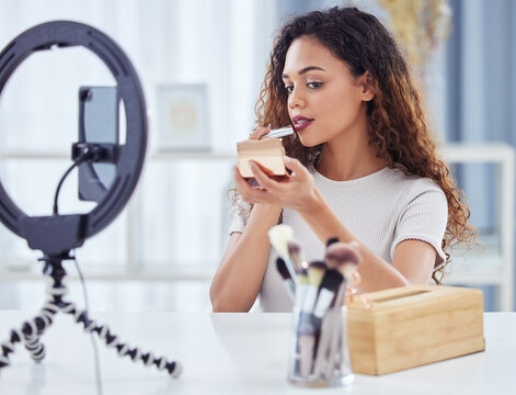 Makeup influencer, lipstick and woman streaming tutorial for beauty, fashion and broadcast for cosmetics. Live stream, filming and content creator or make up artist vlogging with phone and ring light
