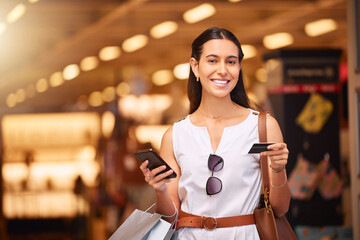 Phone, credit card and a woman with a shopping bag in mall for fashion, sale or discount deal. Portrait of happy customer person with smartphone for retail promotion offer and online banking app