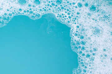 Detergent foam bubble on wate. Blue background, Soap sud - obrazy, fototapety, plakaty