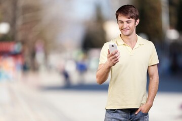 Young happy business man with phone on outdoor