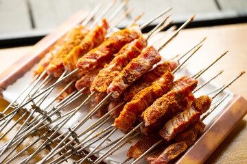 Seasoned raw lamb skewers on a plate
