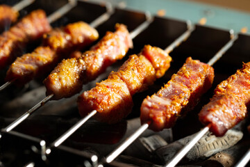Grilled lamb skewers over charcoal