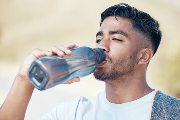 Man, fitness and drinking water in nature for hydration, running exercise or cardio workout...