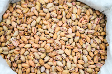 Pistachios at a market. Nuts with shell close-up.
