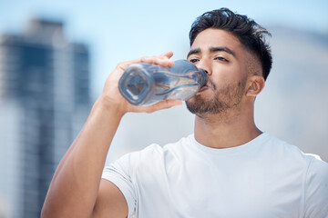Man, fitness and drinking water in city workout, cardio exercise or running for sustainability outdoors. Thirsty male person, athlete or runner with drink for hydration, rest or break in urban town