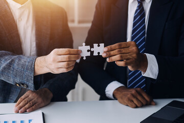 Cropped shot of Businesswoman hand connecting jigsaw puzzle with sunlight effect, Business solutions, success, and Assembling jigsaw pieces, strategy ideas.