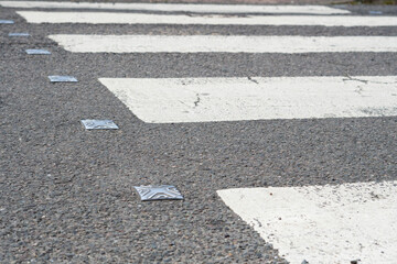 Whote line of crosswalk on the asphalt road on the town street for pedestrian