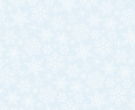 Christmas vector pattern made from white snowflakes on the light blue background