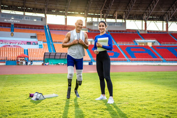 Portrait of Asian para-athlete disabled and trainer standing in stadium. 