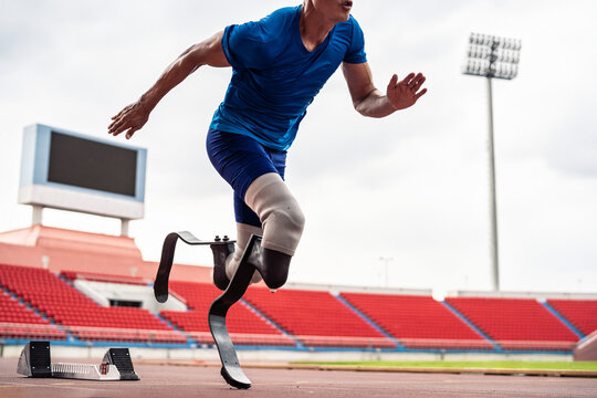 Close up of para-athletes disabled with prosthetic blades run at stadium