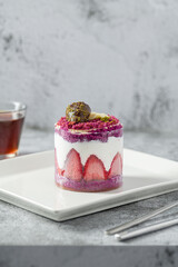 Strawberry shortcake with tea on a white porcelain plate