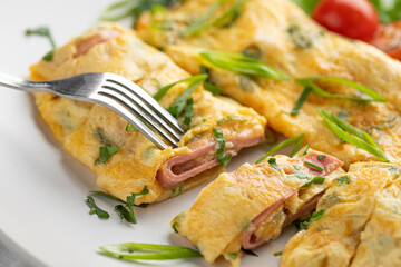 Portion of gourmet omelette breakfast with ham
