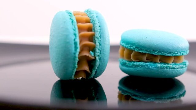 swirling blue macaron lavender or bru cheese flavor on black plate swirling delicious dessert restaurant serving sweetness french dessert lunch chef dish