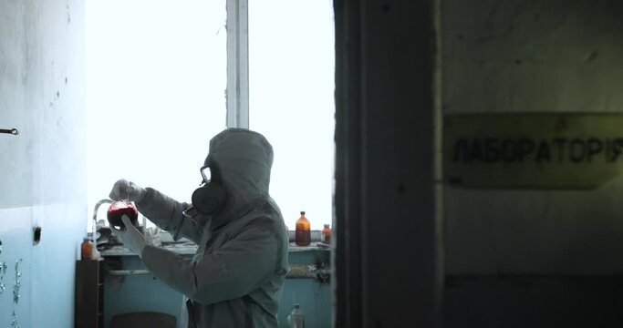 Scientist doctor in protective clothing and gas mask in danger zone. Chemystry. Radioactive threat. Close-up.