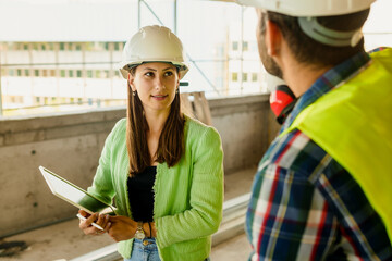 Architect and foreman meeting at construction site,Architect inspects the construction...