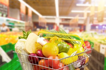 Full of groceries shopping cart inside a supermarket