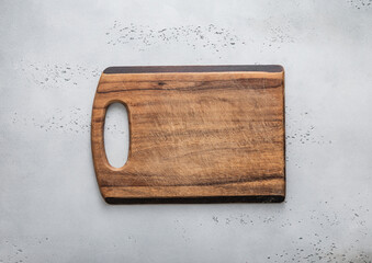Old empty wooden cutting chopping kitchen board on light background.