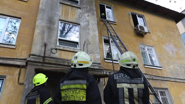 View of a brave firefighter in a protective uniform. Rescuer in protective gear. Firefighters put out a fire in a residential building. DNIPRO, UKRAINE  April 30, 2021