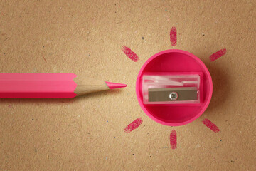 Pink pencil with pink sharpener on recycled paper background - Concept of women and creative thinking