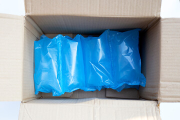 Blue air cushion plastic bags of packaging in cardboard box