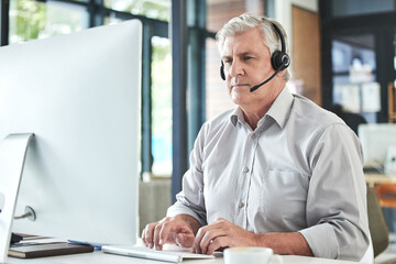 Mature, contact us and call center writing of a professional at a computer for telemarketing job....