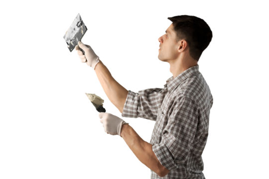 A worker with wall plastering tools for renovating house.