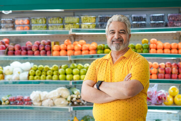 Senior indian man standing at fruit shop. Healthy lifestyle concept.