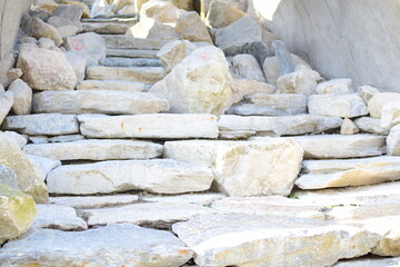 Close-up of upward steps made of light-colored stone