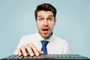 Shocked scared young employee IT business man corporate lawyer wear classic formal shirt tie work in office hold use laptop pc computer isolated on plain pastel light blue background studio portrait.