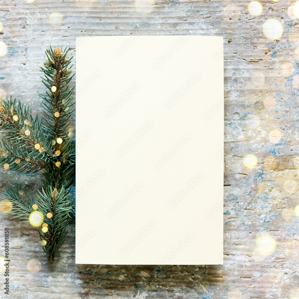 Canvas Prints Christmas still festive life. Blank invitation mockup on old wooden background. Fir branches on the table. Copy space, top view.	