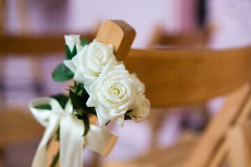 Wooden chairs with floral decor. Loft interior. Wedding decorations.	