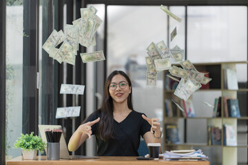 Excited young Asian businesswoman in modern office celebrating financial success profit business throwing money banknotes. Successful career.