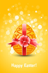 Golden Egg with ornament decoration and sparkles on orange background