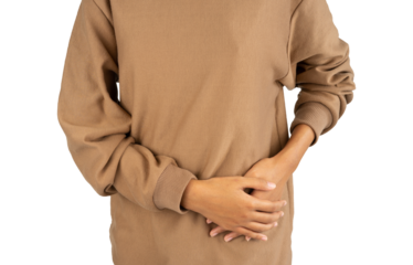 woman holding side belly with two hands